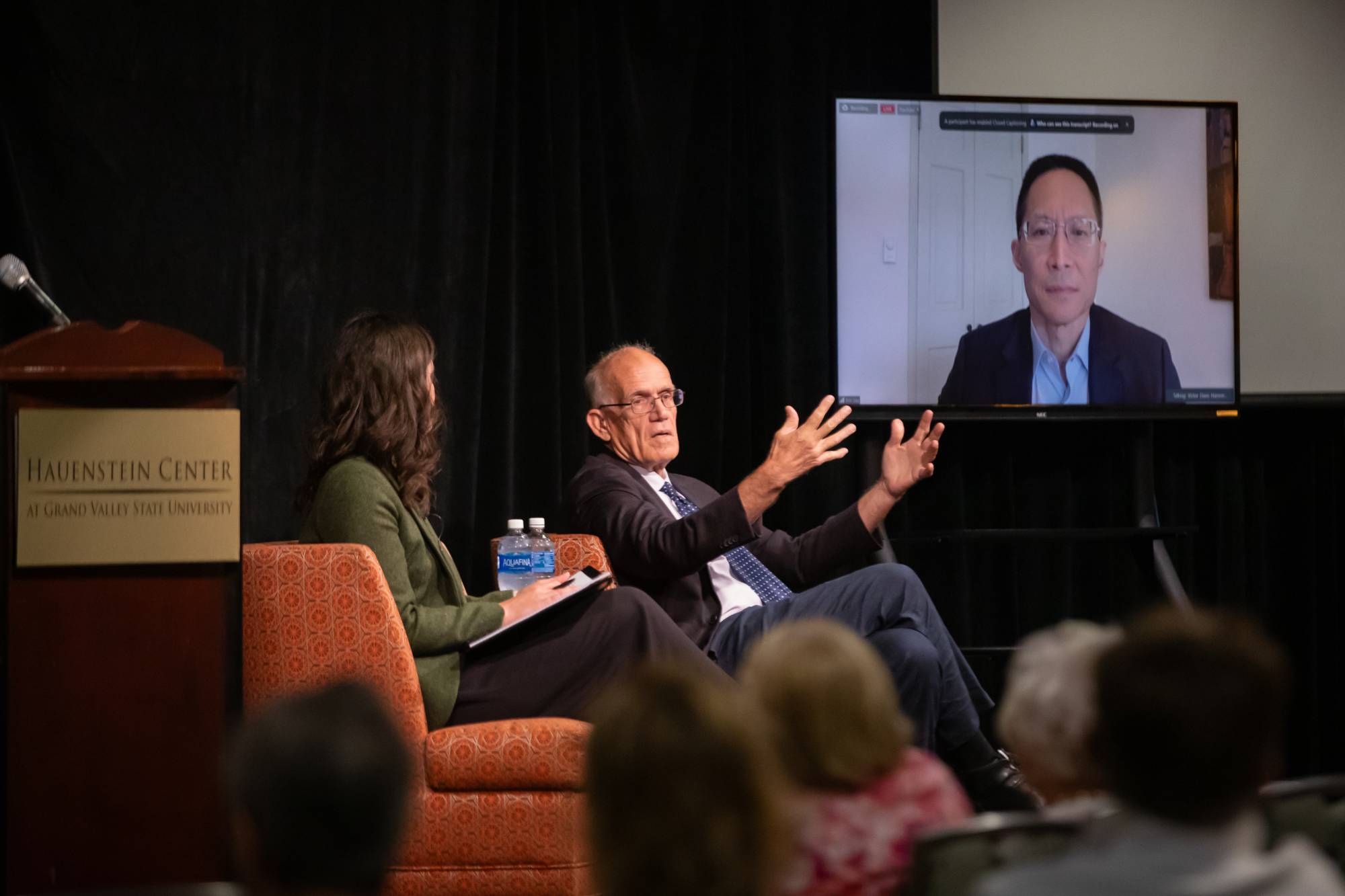 three people on a stage
